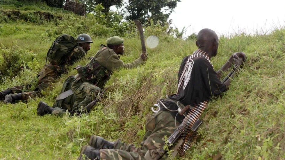 Congolese soldiers hold their positions as they advance against the M23 rebels near the Rumangabo military base in Runyoni, 58 km (36 miles) north of Goma, October 31, 2013. Congo's army said on Thursday it was hunting rebels deep in the forests and mountains along the border with Rwanda and Uganda, the insurgents' last hideouts after they were driven from towns they seized during a 20-month rebellion.
