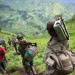 This picture taken on November 30, 2012 shows M23 rebels withdrawing through the hills having left their position in the village of Karuba, eastern Democratic Republic of Congo. Congolese troops on November 4, 2013 drove M23 rebels from one of the steep hilltops where they have holed up after being driven from their last stronghold in the east of the country, a senior official said. The army has "completely conquered" the Mbuzi hilltop after pounding rebel positions in the mountainous region