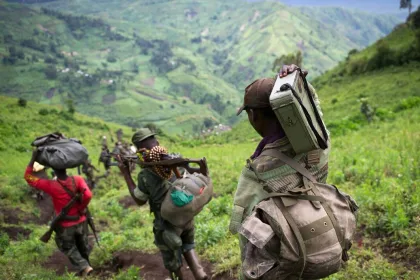This picture taken on November 30, 2012 shows M23 rebels withdrawing through the hills having left their position in the village of Karuba, eastern Democratic Republic of Congo. Congolese troops on November 4, 2013 drove M23 rebels from one of the steep hilltops where they have holed up after being driven from their last stronghold in the east of the country, a senior official said. The army has "completely conquered" the Mbuzi hilltop after pounding rebel positions in the mountainous region